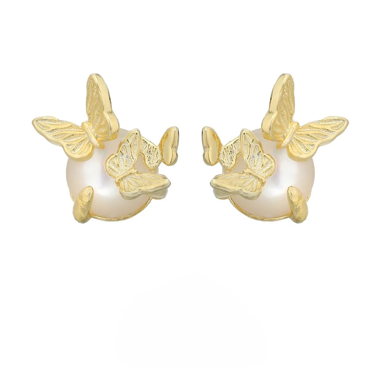 Close-up of a pair of silver butterfly stud earrings with a gold-toned finish.