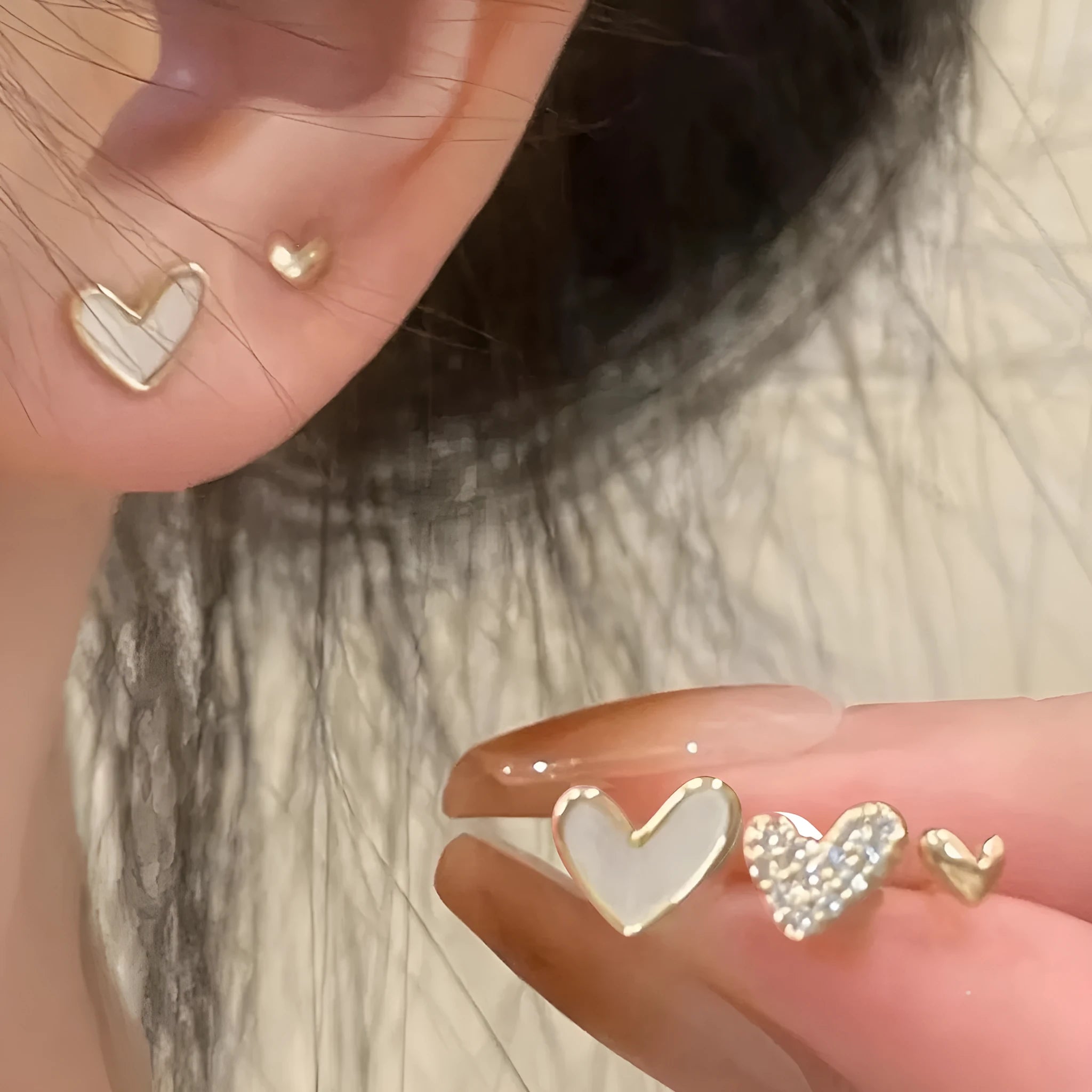 Women's heart-shaped earring set with three pairs in gold, black, black and white, and pink electroplated colours