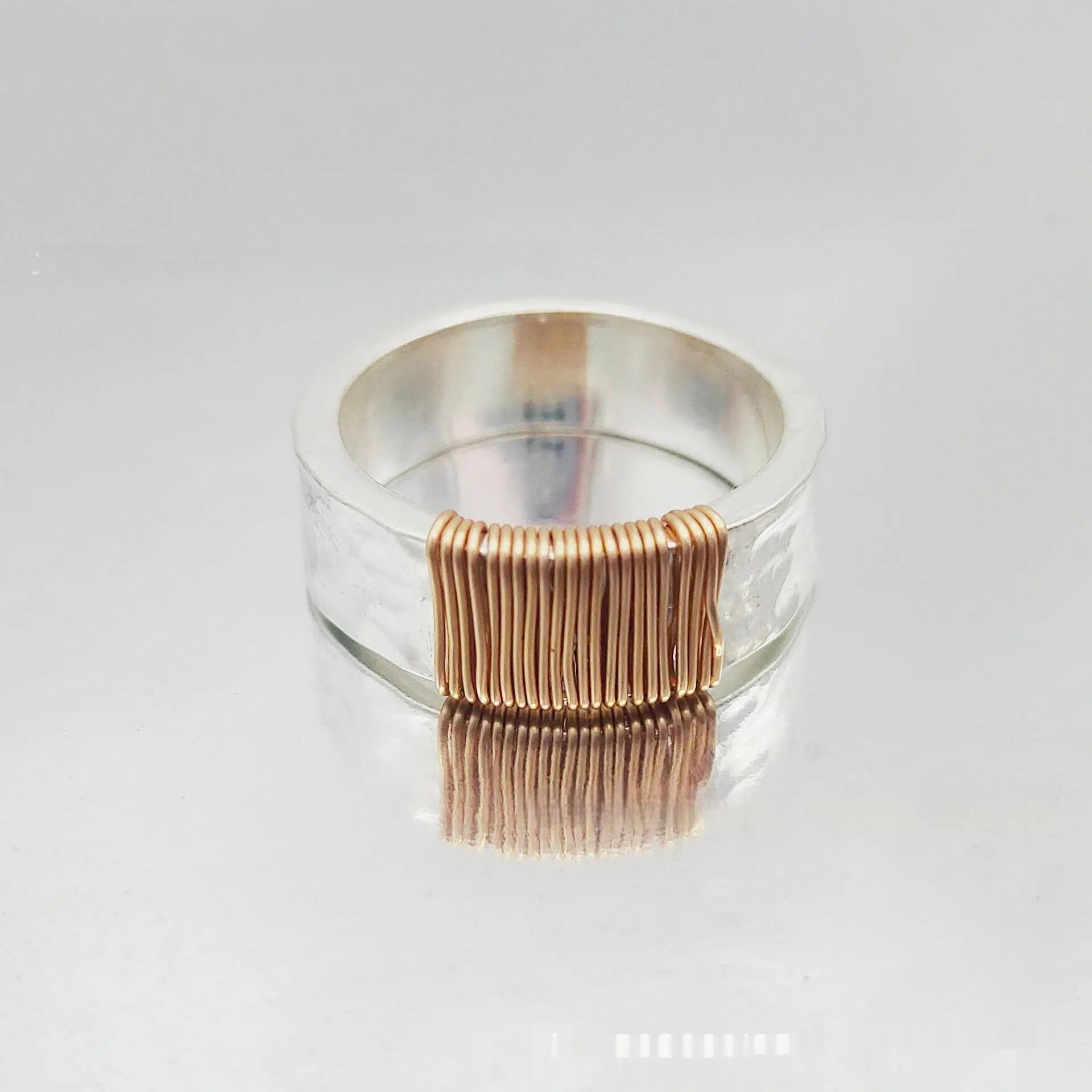 Copper geometric wide-face bracelet with irregular coil design in silver gold electroplated finish