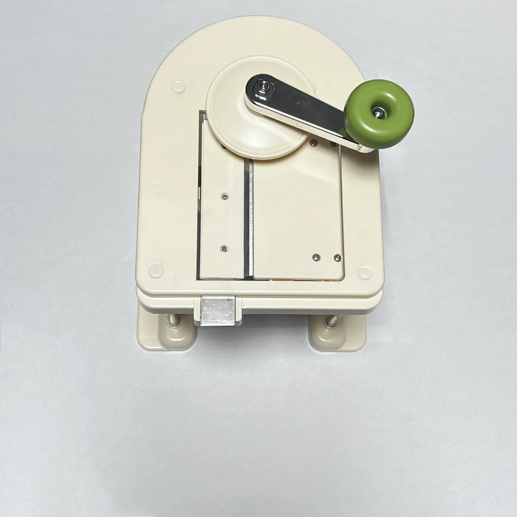 Beige stainless steel kitchen slicer grater with multiple blades for vegetable preparation