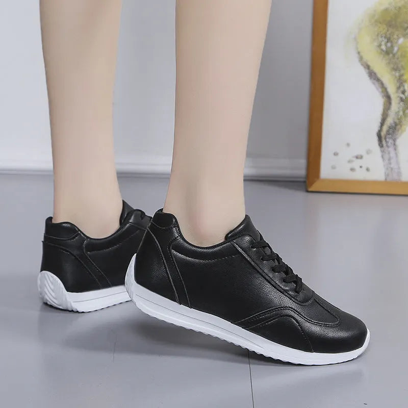 Women's white platform casual sneakers with thick sole, lace-up closure, and rubber outsole on a neutral background