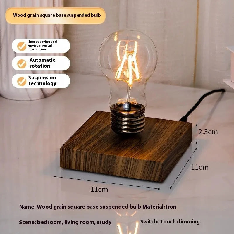 Creative iron art night lamp with a suspended bulb on a black wood grain base.
