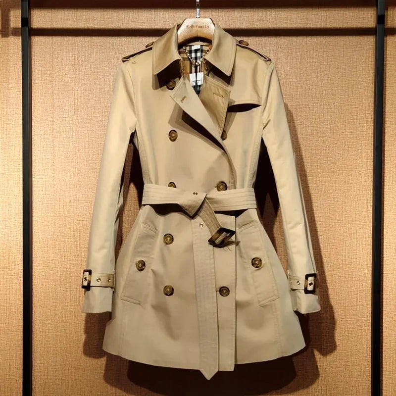 Khaki women's double-breasted trench coat with long sleeves and button fastenings.