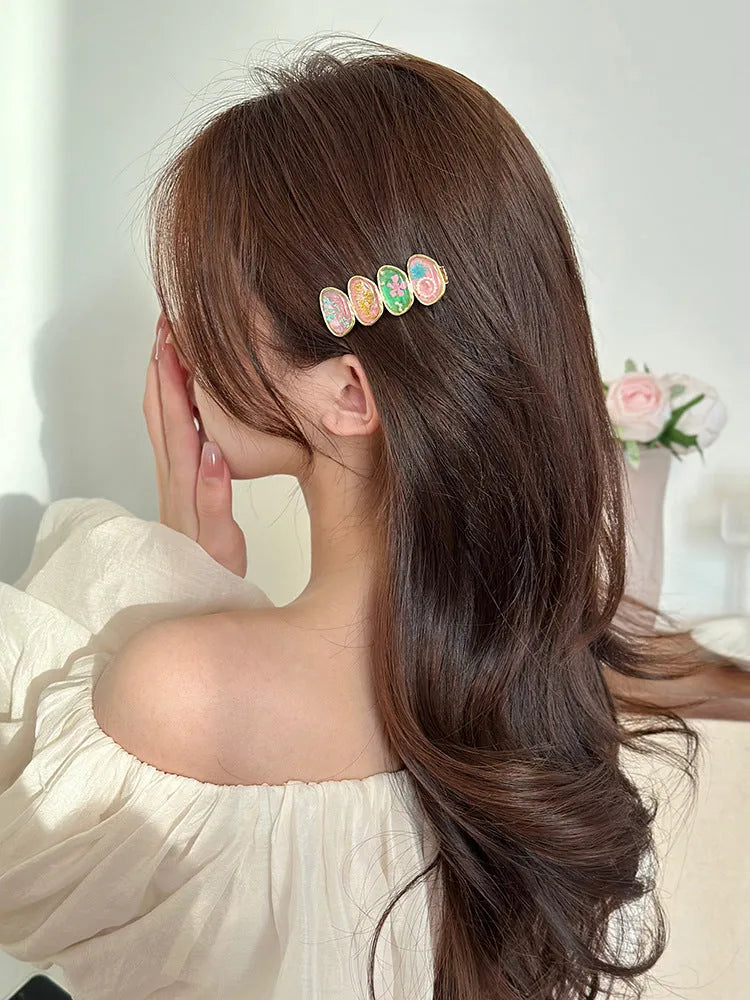 Forest Fairy side bangs hair clip in pink and yellow plastic resin with lines pattern for women