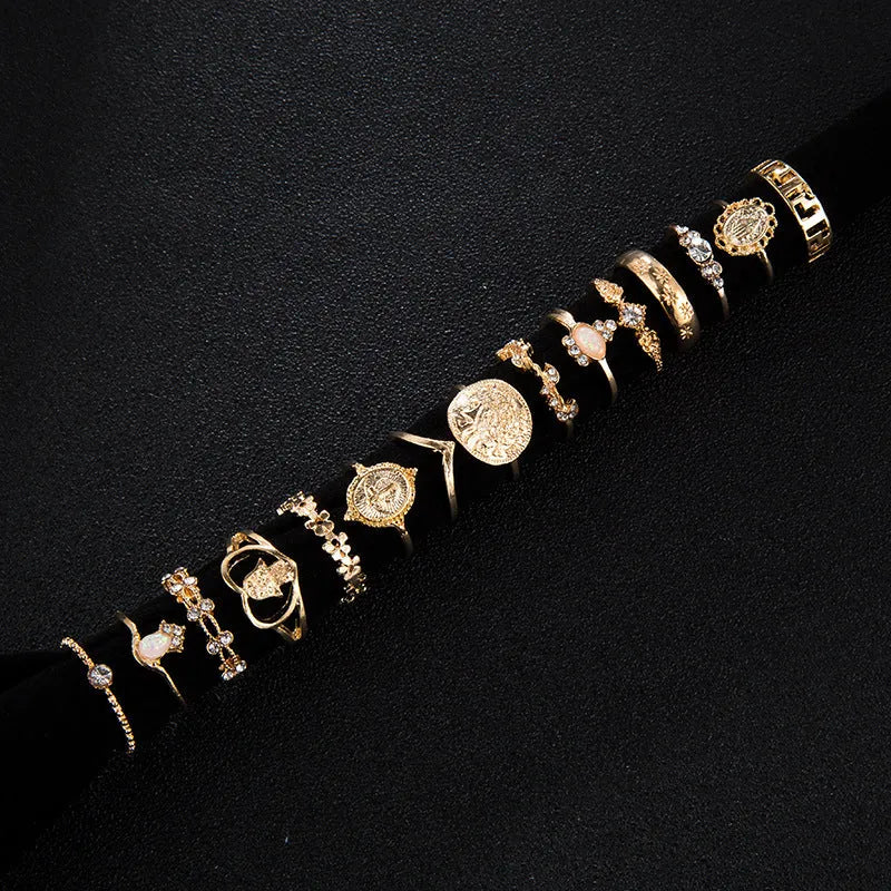 12-piece cross ring set in gold alloy on a flat surface, showing one size design