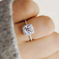 Geometric sculpted platinum alloy ring with diamond insert on white background