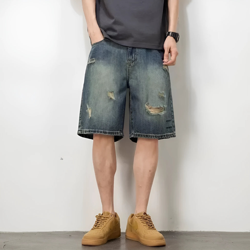 Blue retro loose hole men's denim shorts on a neutral background