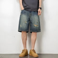 Blue retro loose hole men's denim shorts on a neutral background