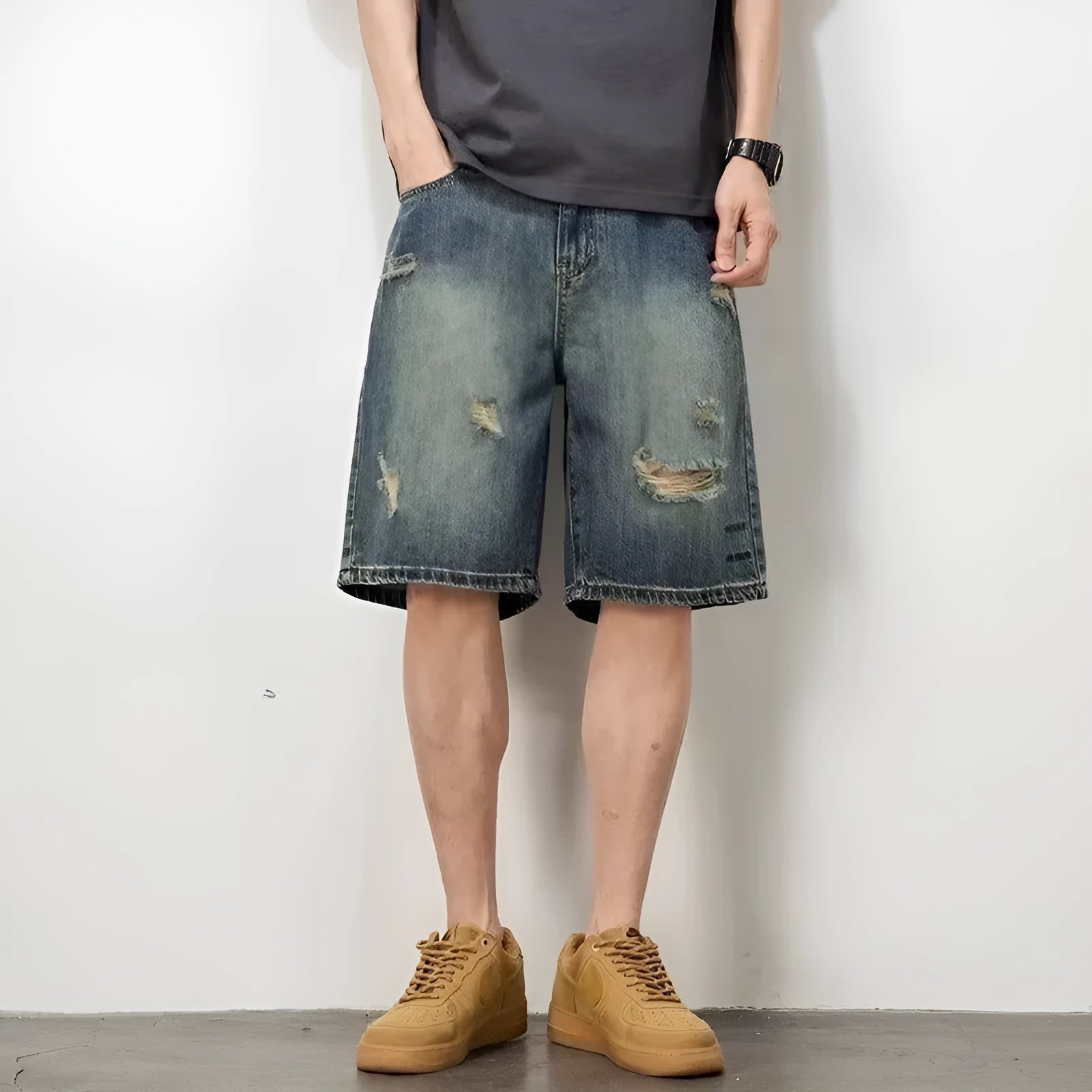 Blue retro loose hole men's denim shorts on a neutral background