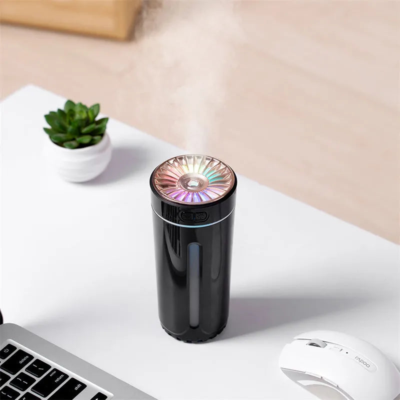 Black and white portable USB rechargeable humidifier with colourful lights for car and desktop use.