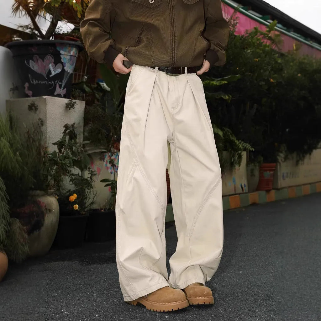 Men's pleated straight-leg trousers in apricot colour on a hanger