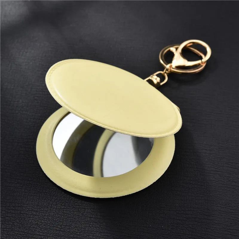 Compact round ladies leather makeup mirror with 8cm diameter glass surface and golden buckle