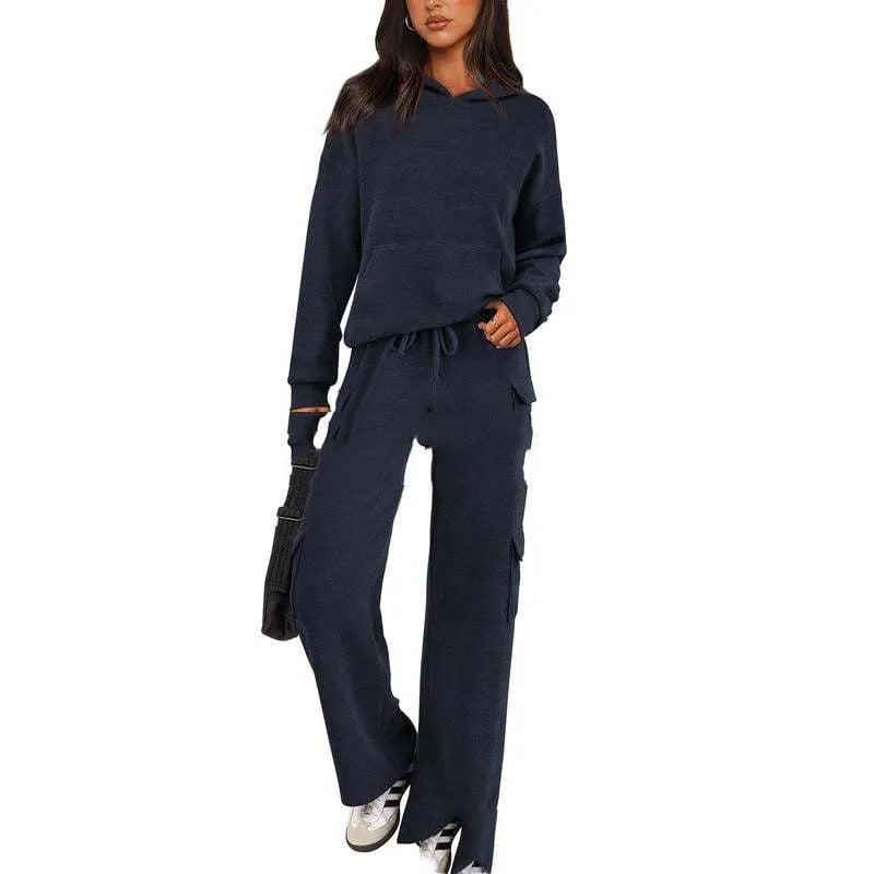 Women's black polyester leisure sports suit set with long sleeves and trousers laid flat.