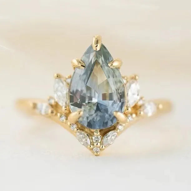 Gold alloy women's floral ring with blue crystal diamond inlay, side view