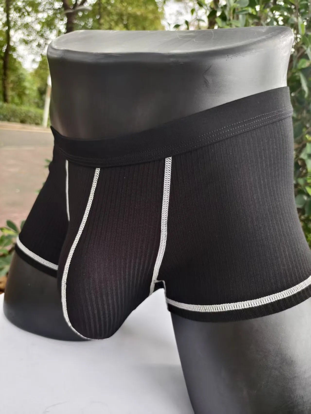 Men's solid colour breathable fibre boxer shorts shown in army green, demonstrating thin fabric and fit.