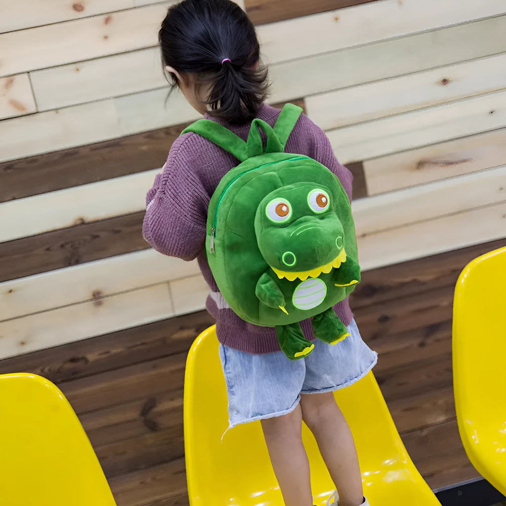 Soft blue dinosaur plush backpack for children with embroidered dinosaur pattern and a soft handle.