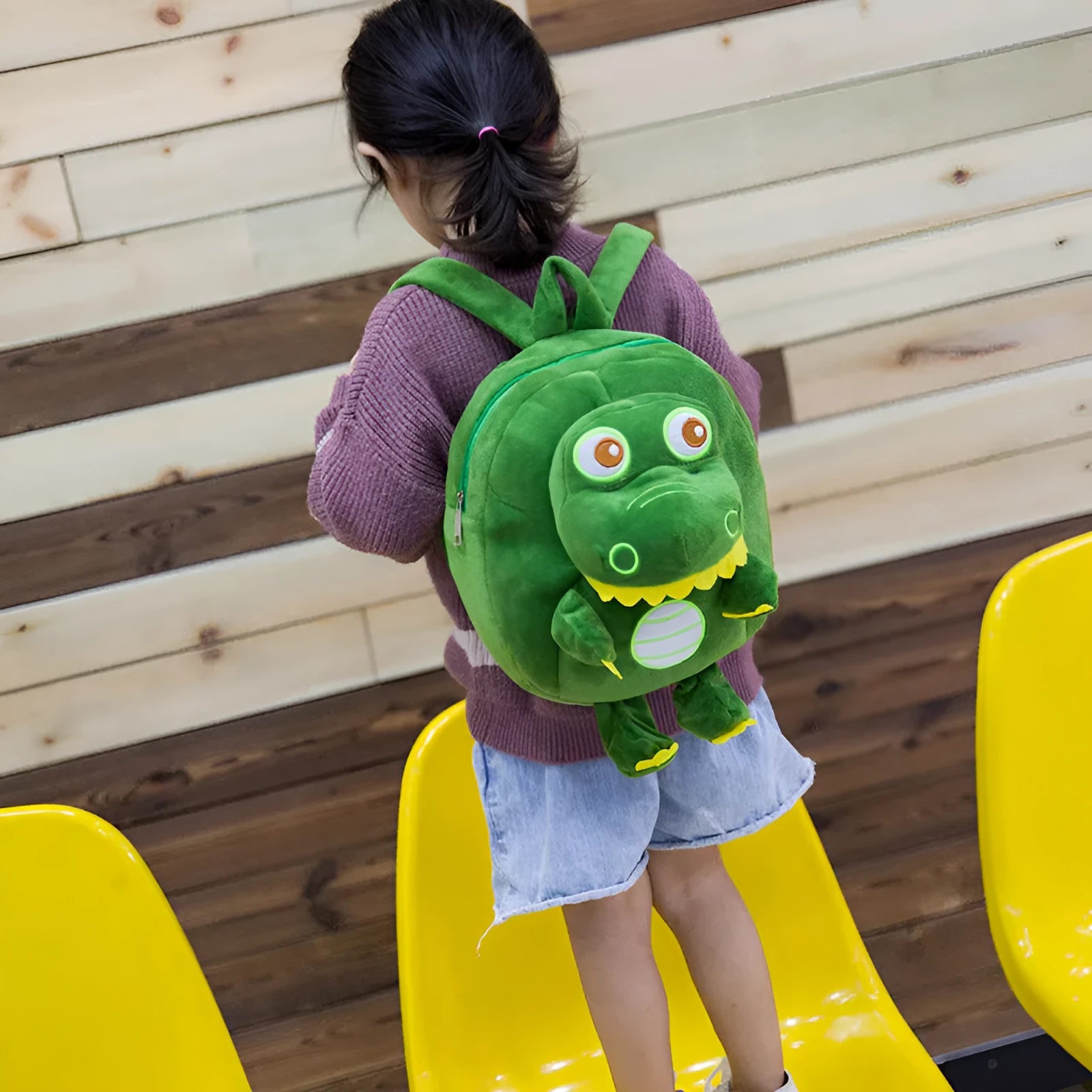Soft blue dinosaur plush backpack for children with embroidered dinosaur pattern and a soft handle.