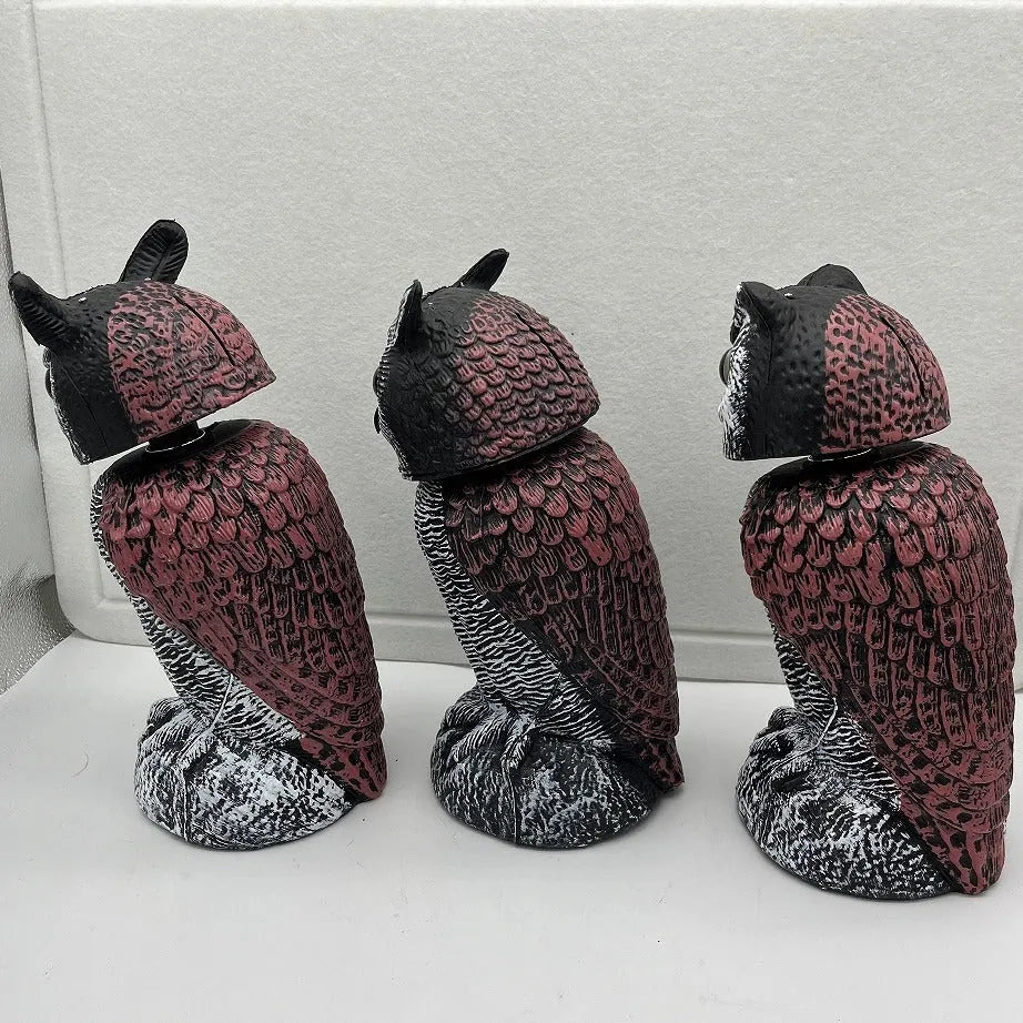 Artificial owl bird scarer decoy with shaking head motion in outdoor setting
