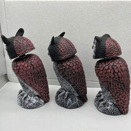 Artificial owl bird scarer decoy with shaking head motion in outdoor setting