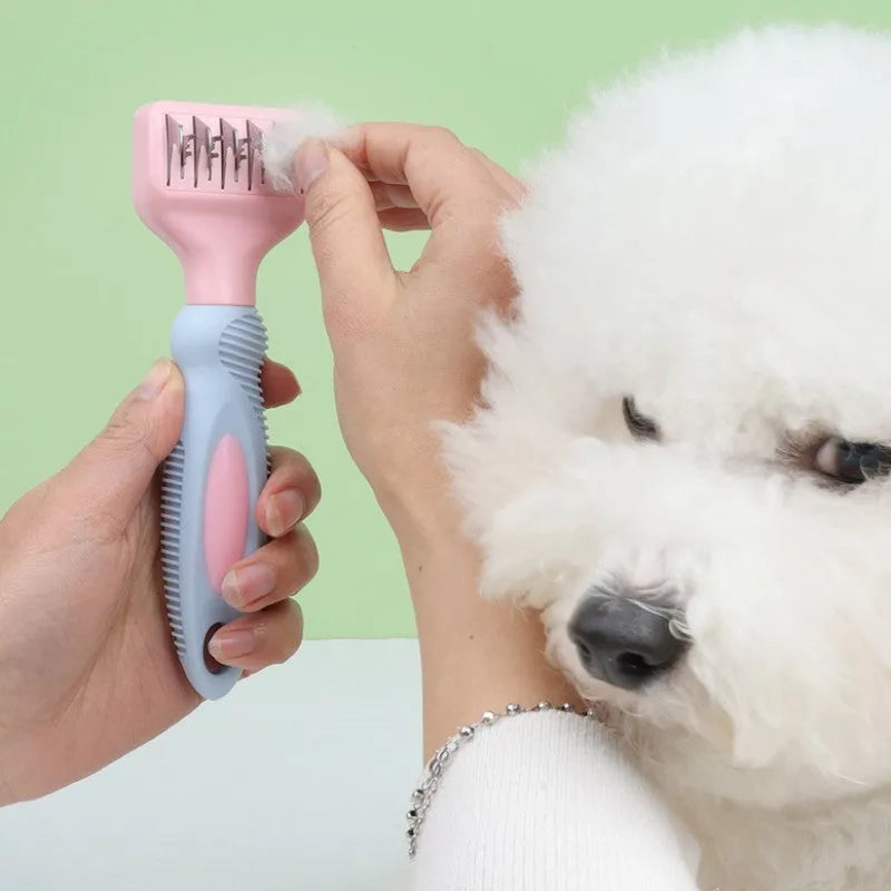 Pink stainless steel dog comb and brush tool with a knot knife edge for pet grooming.