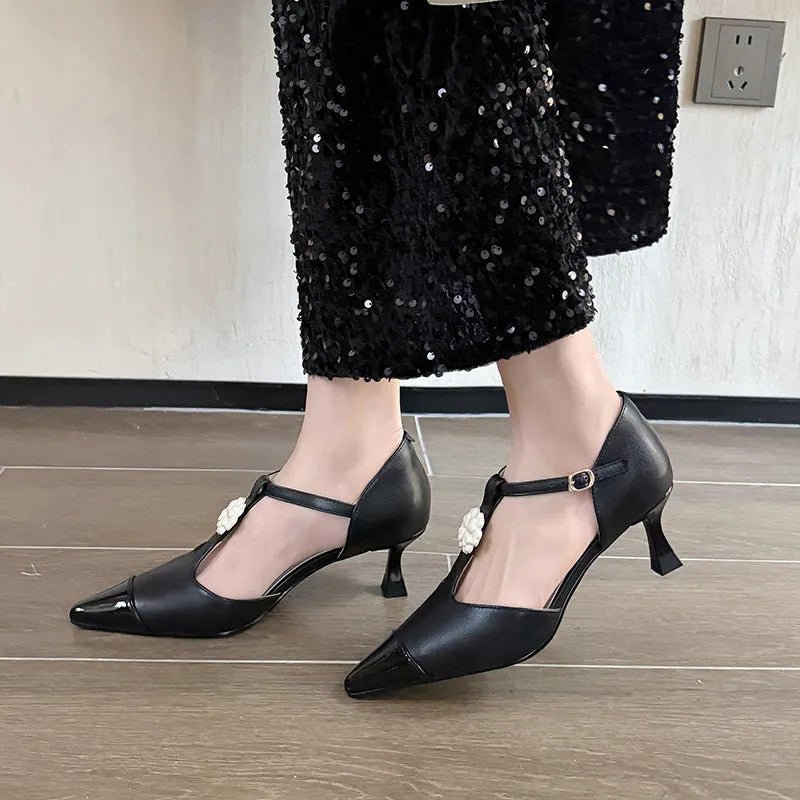 Women's gold stiletto heel shoe with pointed toe, flower buckle, and shallow mouth design on a beef tendon sole.