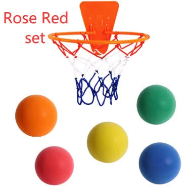 Assortment of bright coloured silent foam basketballs with a basketball frame on a neutral background