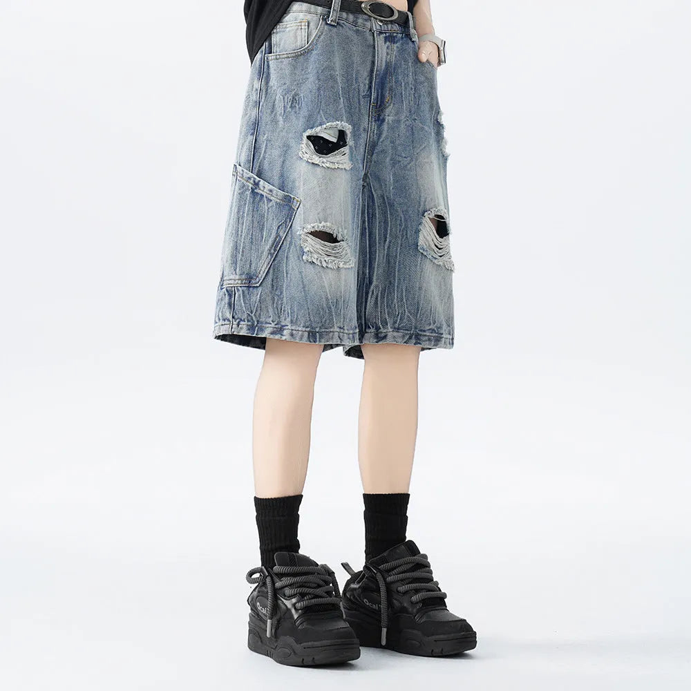 Women's washed denim shorts with ripped detailing in loose retro fit, shown in black and blue colour options