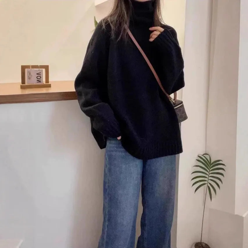 Women's loose grey turtleneck sweater with a thick, textured curling pile collar
