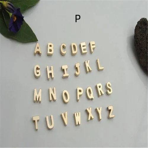Golden peach heart shaped alloy necklace pendant with a letter design on a white background.