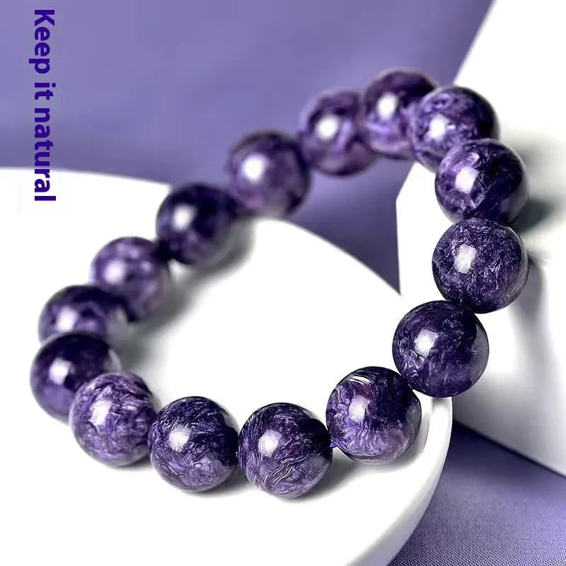 Natural transparent charoite crystal bracelet with platinum clasp, showing different bead size options.