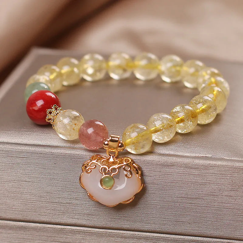 Women's pendant bracelet with a yellow natural citrine jade ruyi charm on an alloy chain.
