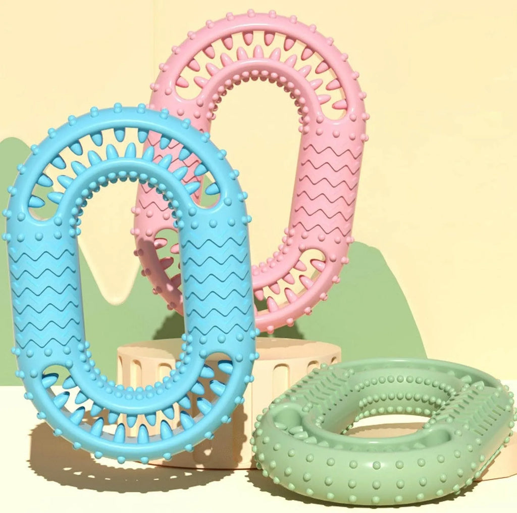 Blue O-ring shaped dog chew toy for aggressive chewers and dental health on a plain background.