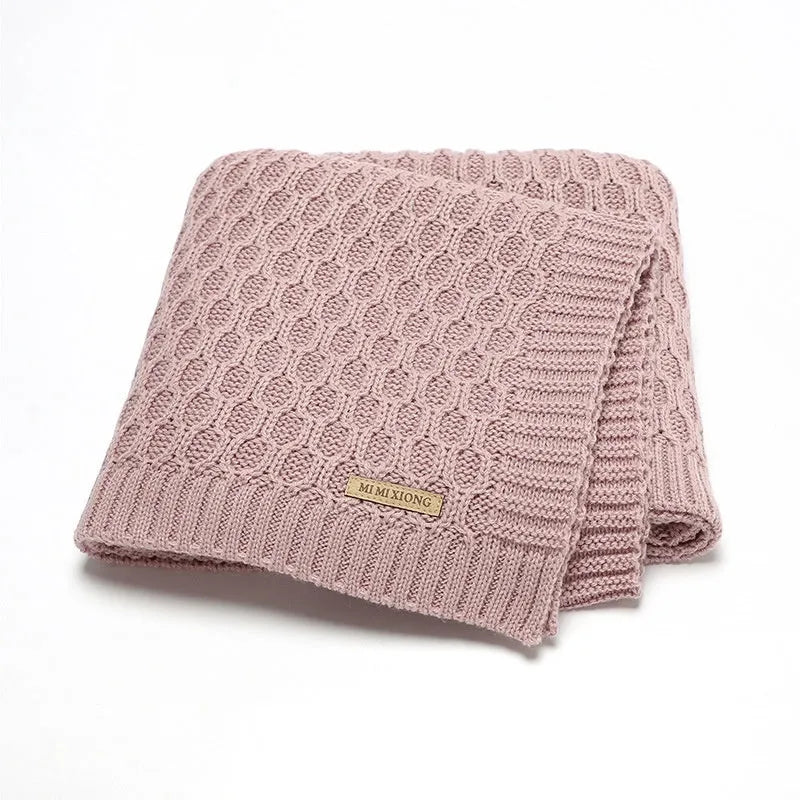 Solid-colour infant blanket with raised three-dimensional lines, shown in a light green colour.