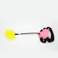 Green cat toy funny cat stick with strong feathers on a plain background