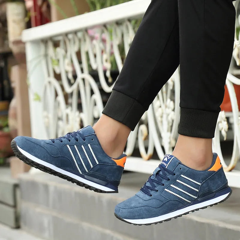 Blue leather sneakers for men with low-top design, pigskin upper, and rubber sole on a plain background