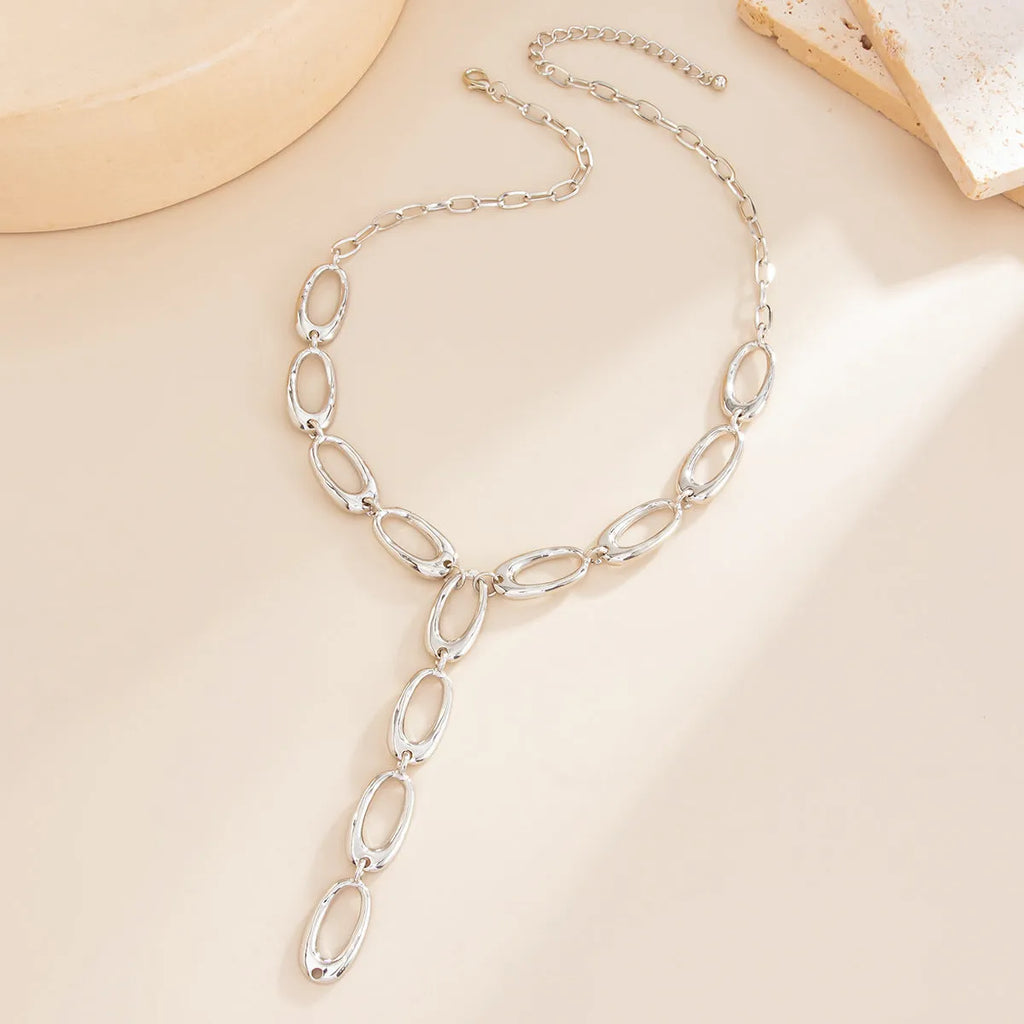 Metal textured Y-shaped cross necklace with alloy chain in gold finish on white background