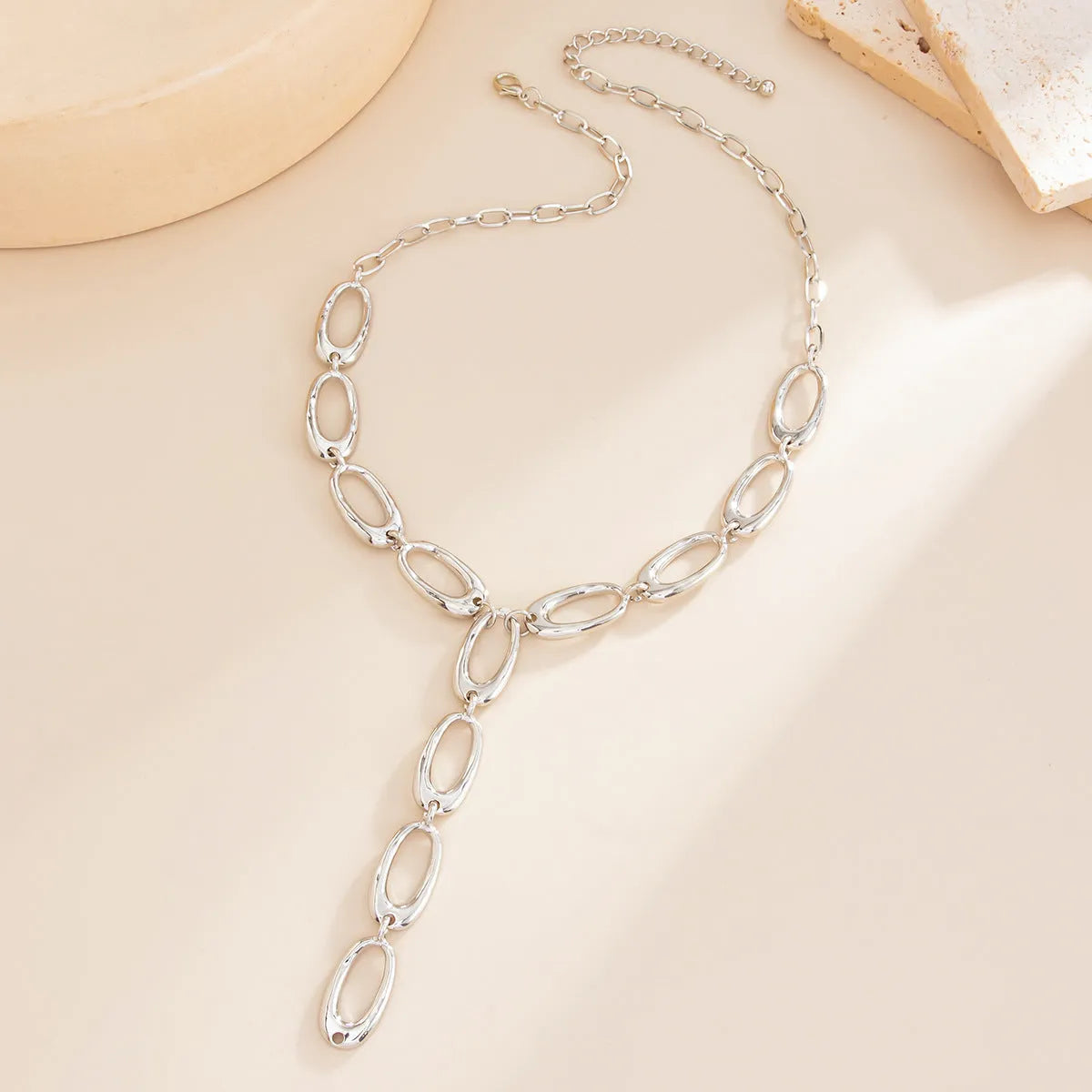 Metal textured Y-shaped cross necklace with alloy chain in gold finish on white background
