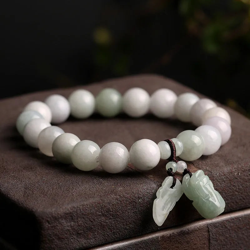 Natural green jade geometric bracelet with an adjustable chain and a hanging Maitreya Buddha charm.