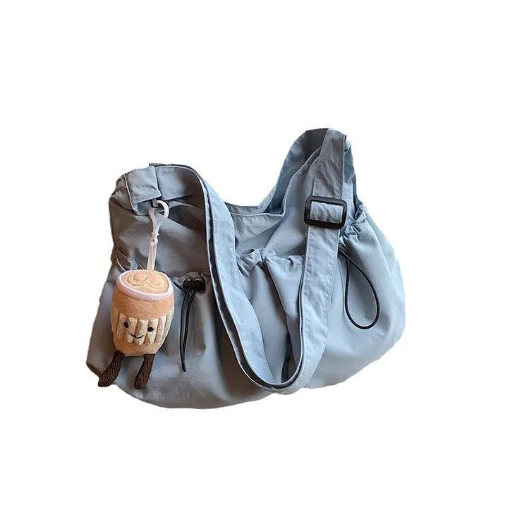Ultra-light pleated foldable crossbody bag in beige, showing split pocket and crossbody strap.