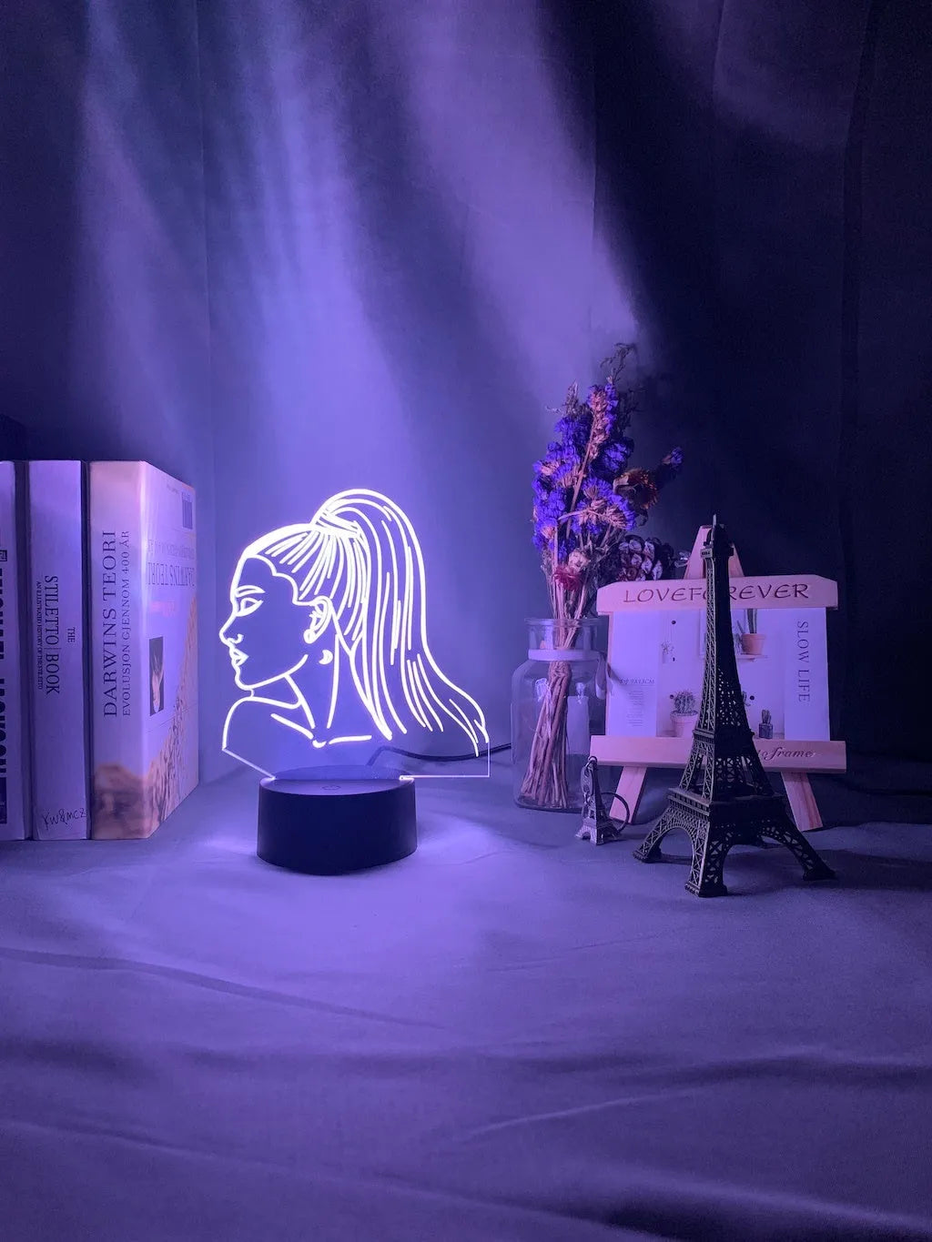Slim black-based acrylic 3D LED night light showing colour display on wall