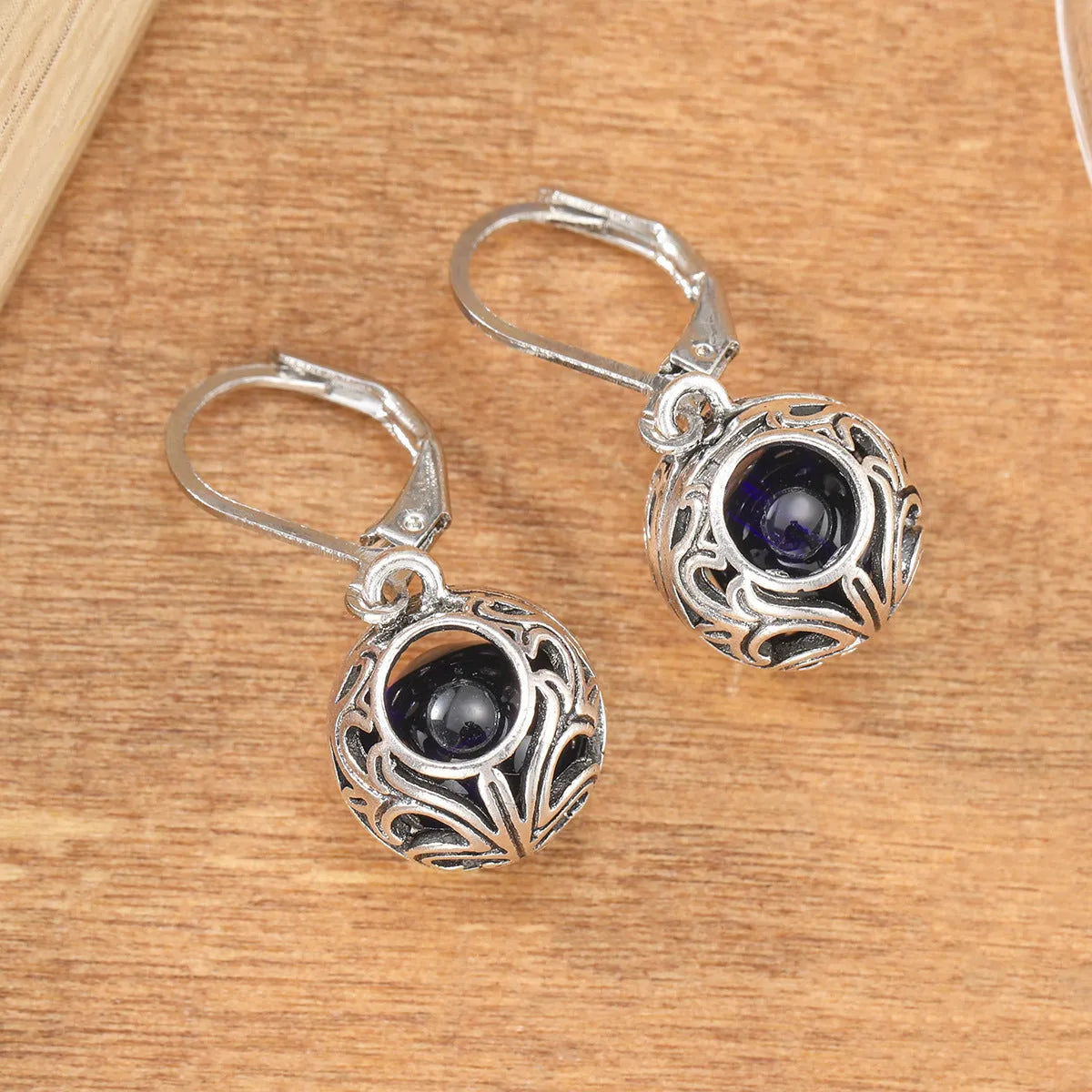 Silver geometric vintage engraving hollow drop earrings with blue gemstone centre