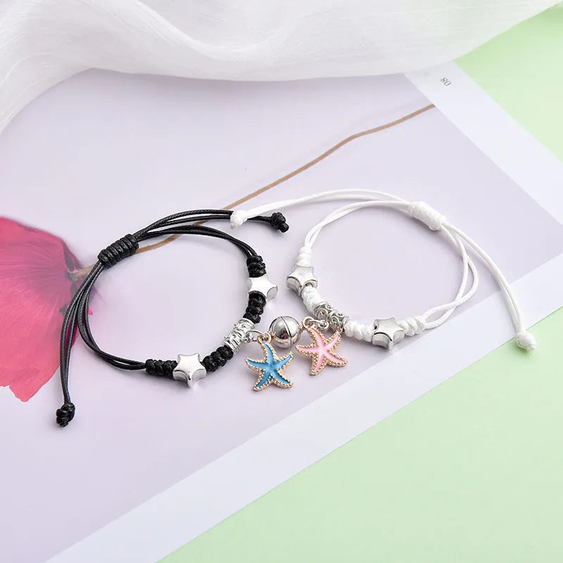 Magnetic clasp couple bracelets with alloy construction and symbolic designs including crown and love lock motifs.