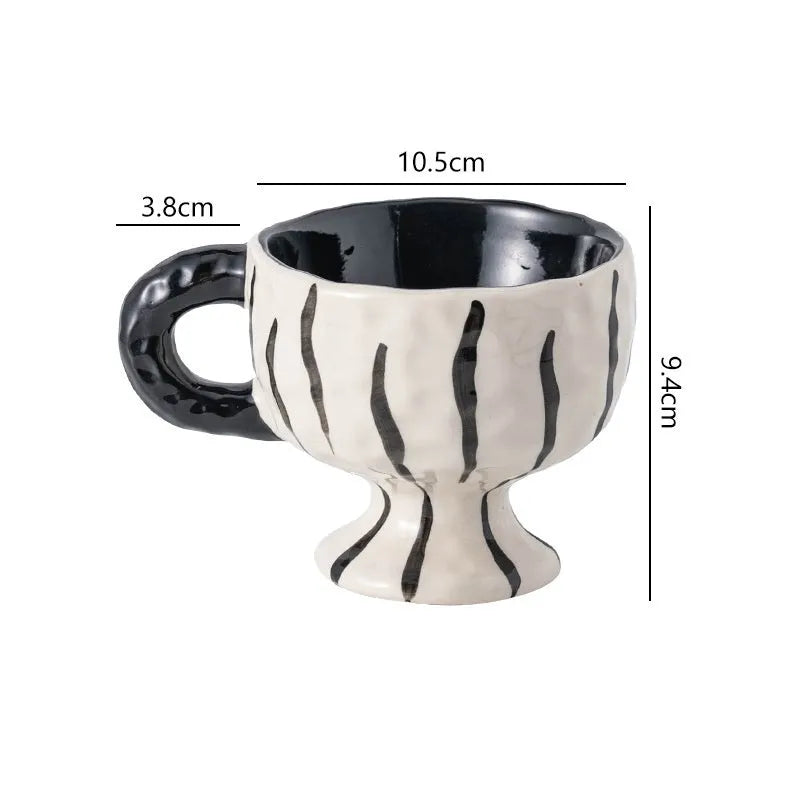 Hand-pinched irregular ceramic mug in solid colour with modern design
