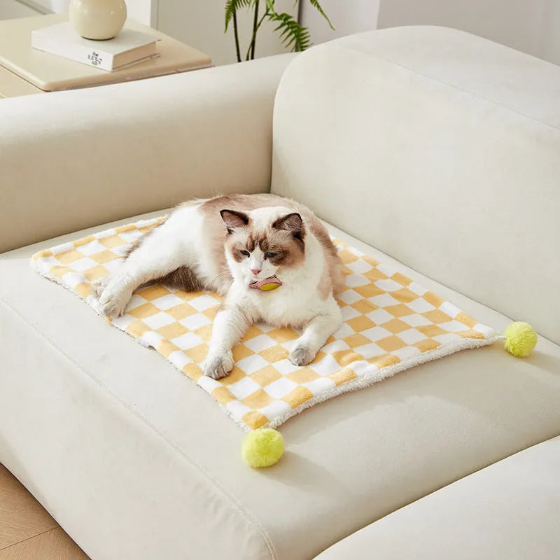 Green plaid pattern plush pet blanket for cats and dogs on a sofa