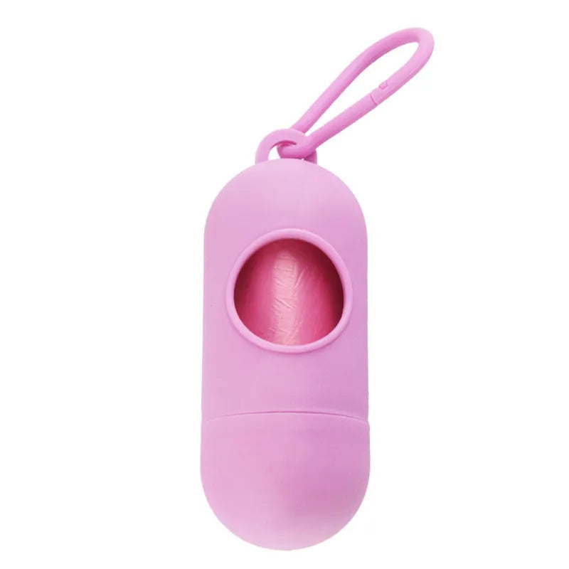 Black plastic dog poop bag holder with a metal side hook and Velcro strap, showing compact size.