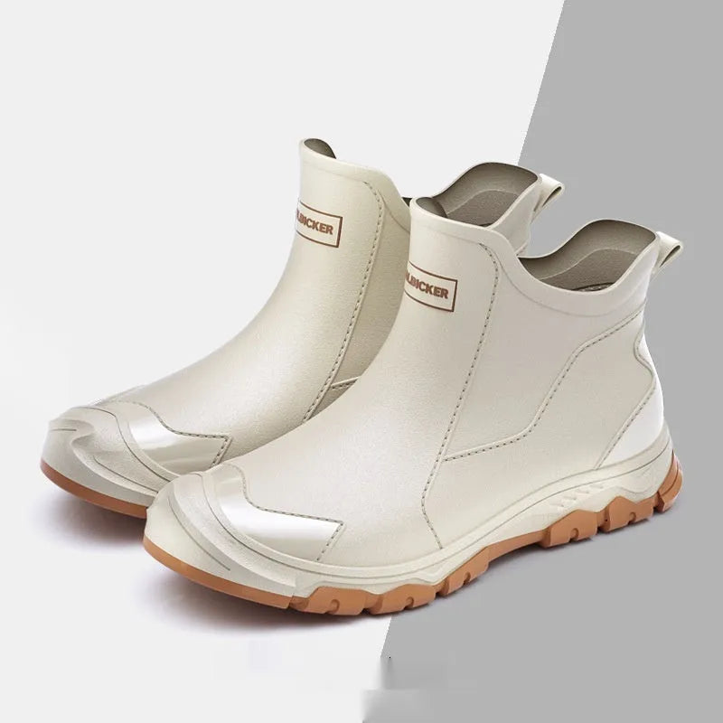 PVC outdoor wading boots in beige and black with red, showing round toe and non-slip plastic sole.