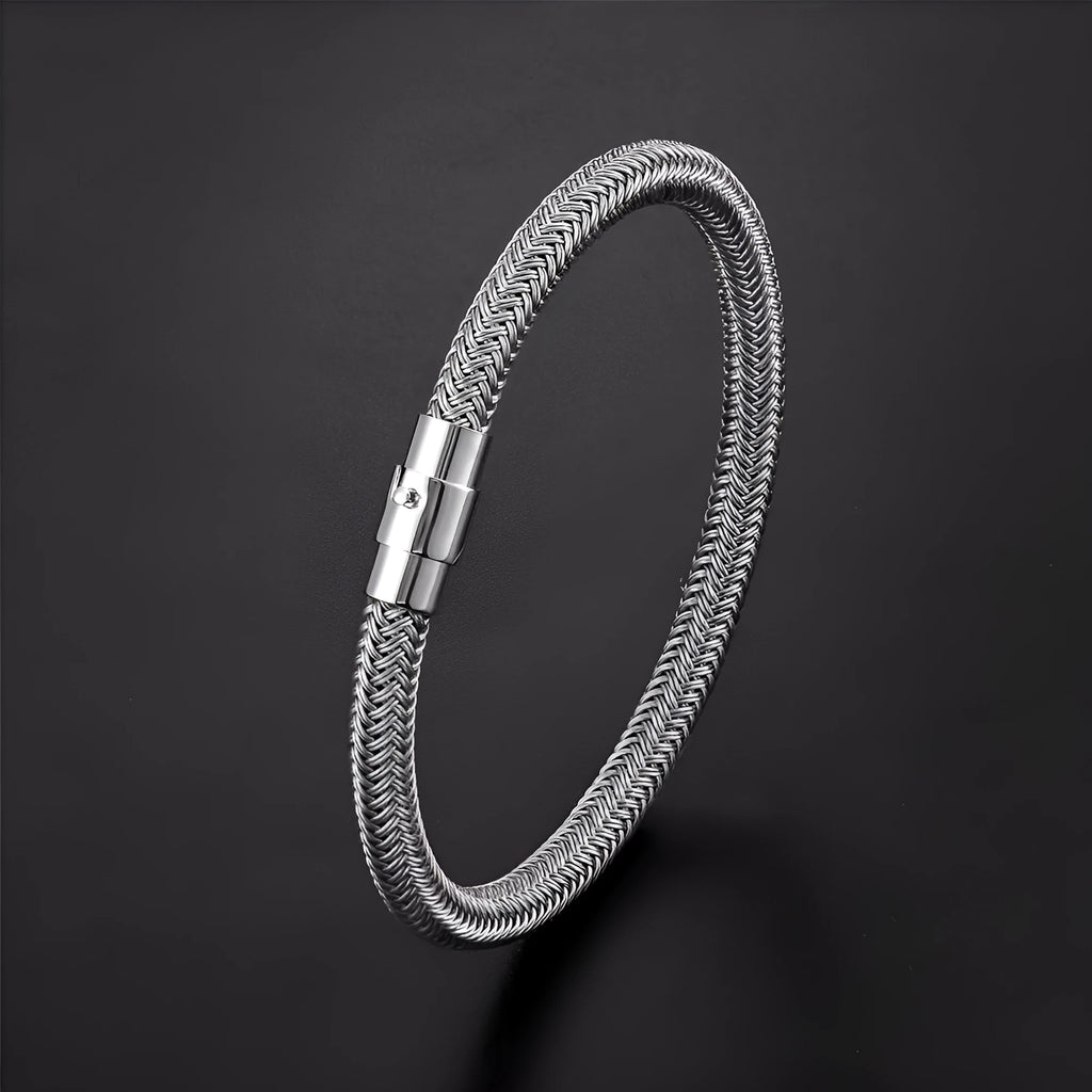 Geometric titanium steel bracelet with a magnetic clasp, shown in a unisex style.