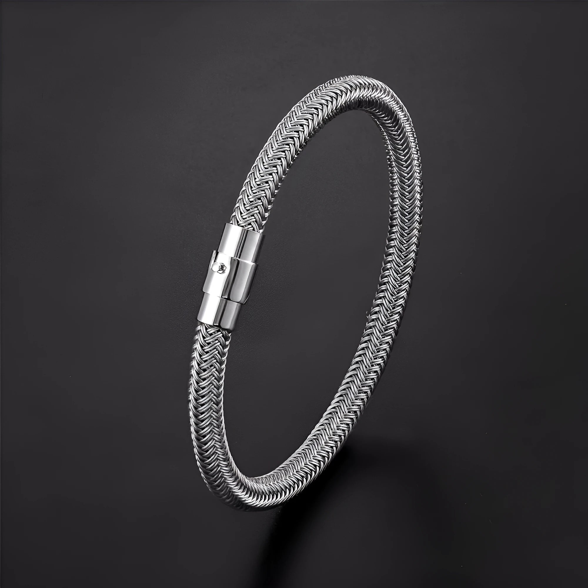 Geometric titanium steel bracelet with a magnetic clasp, shown in a unisex style.