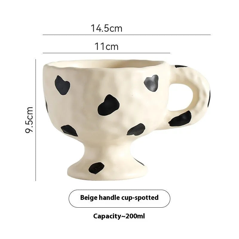 Hand-pinched irregular ceramic mug in solid colour with modern design
