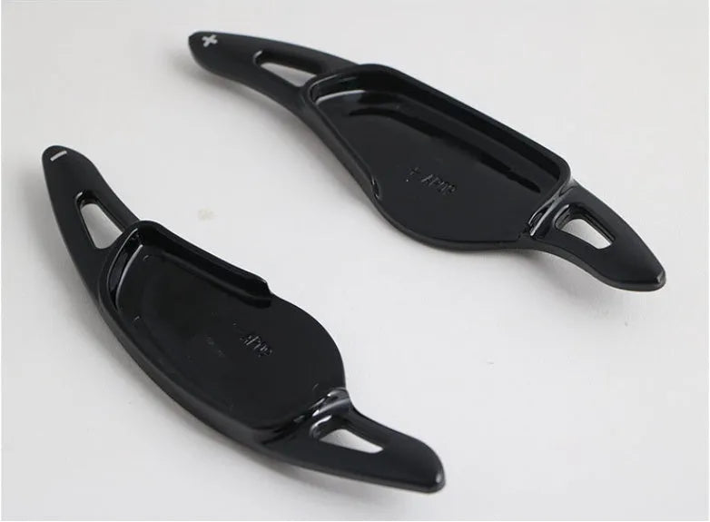 Carbon fibre pattern steering wheel paddle shifters in black and red finishes